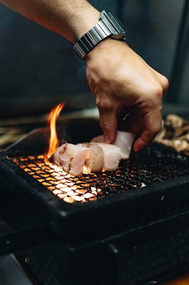 Cuisson d'un poisson sur le grill en cuisine, restaurant à Toulouse